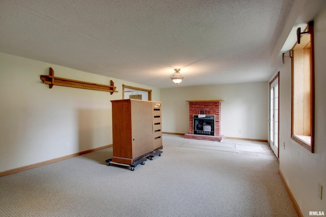 2044 N 1200th Ave, Liberty, IL 62347 - unfurnished living room featuring light colored carpet, a fireplace, baseboards, and a textured ceiling