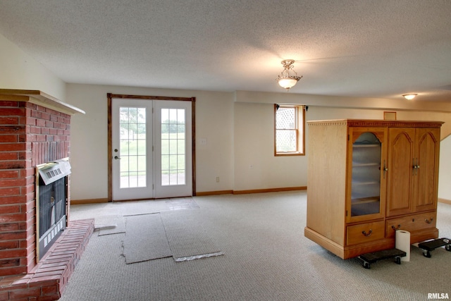 2044 N 1200th Ave, Liberty, IL 62347 - unfurnished living room with light colored carpet, a fireplace, a textured ceiling, baseboards, and heating unit