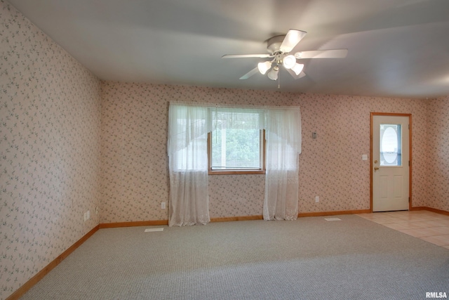 2044 N 1200th Ave, Liberty, IL 62347 - empty room featuring light carpet, a ceiling fan, wallpapered walls, baseboards, and light tile patterned floors