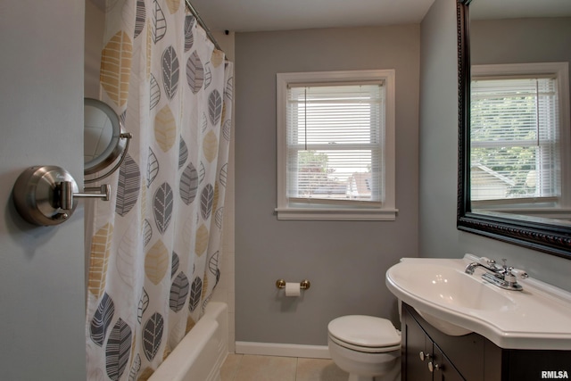 2317 Harrison St, Quincy, IL 62301 - full bathroom with vanity, toilet, plenty of natural light, and tile patterned floors