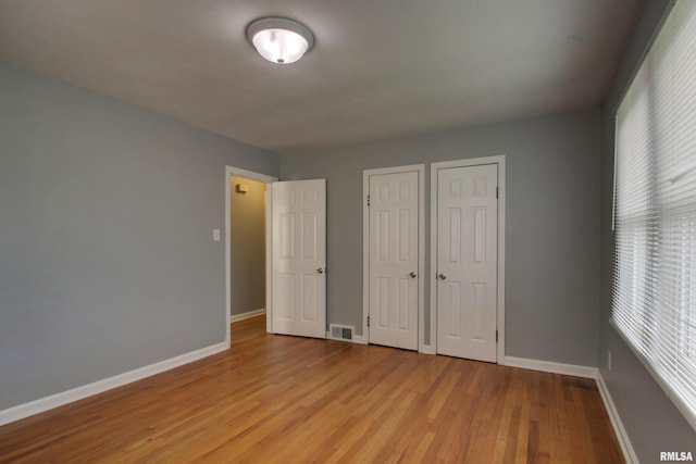 2317 Harrison St, Quincy, IL 62301 - unfurnished bedroom with light wood-type flooring and baseboards