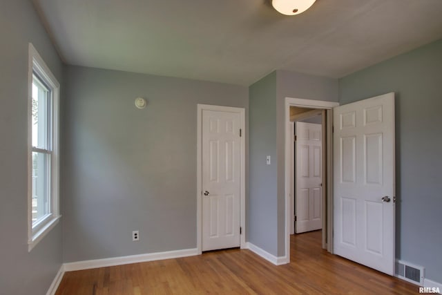 2317 Harrison St, Quincy, IL 62301 - unfurnished bedroom with baseboards and wood finished floors
