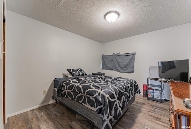 1354 Airport Rd, Lincoln, IL 62656 - bedroom featuring wood finished floors, a textured ceiling, and baseboards