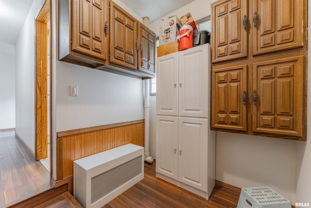 1354 Airport Rd, Lincoln, IL 62656 - kitchen with dark wood finished floors, brown cabinetry, wainscoting, and wood walls