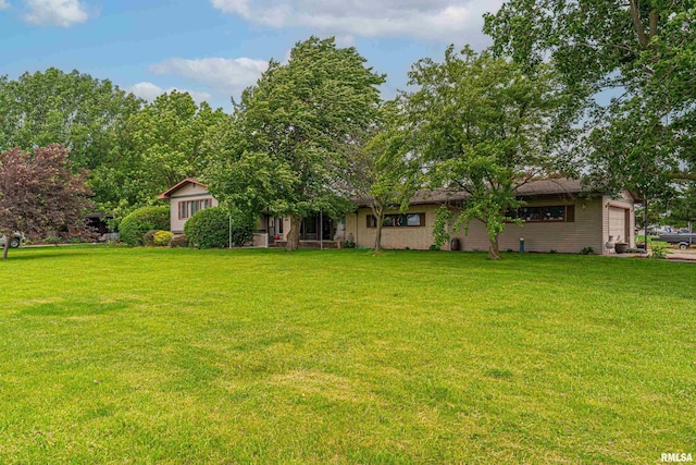 1354 Airport Rd, Lincoln, IL 62656 - view of green lawn with a garage