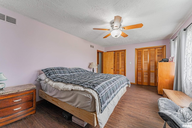 1354 Airport Rd, Lincoln, IL 62656 - bedroom with multiple closets, a textured ceiling, wood finished floors, ceiling fan, and baseboards
