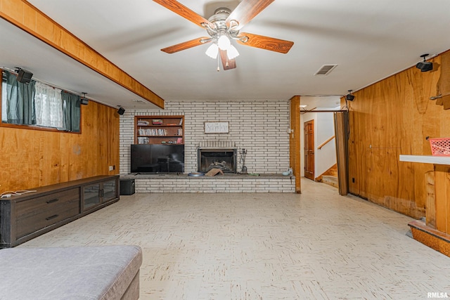 1354 Airport Rd, Lincoln, IL 62656 - unfurnished living room with wooden walls, stairway, a ceiling fan, a fireplace, and beam ceiling