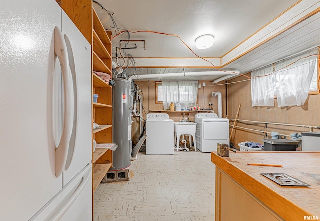 1354 Airport Rd, Lincoln, IL 62656 - below grade area with freestanding refrigerator, washer and clothes dryer, water heater, tile patterned floors, and a sink