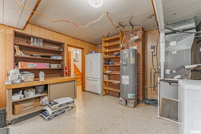 1354 Airport Rd, Lincoln, IL 62656 - basement featuring freestanding refrigerator, water heater, washer / dryer, wood walls, and light flooring