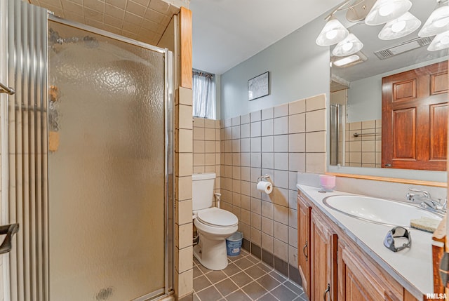 1354 Airport Rd, Lincoln, IL 62656 - bathroom featuring tile walls, tile patterned floors, vanity, a shower stall, and toilet