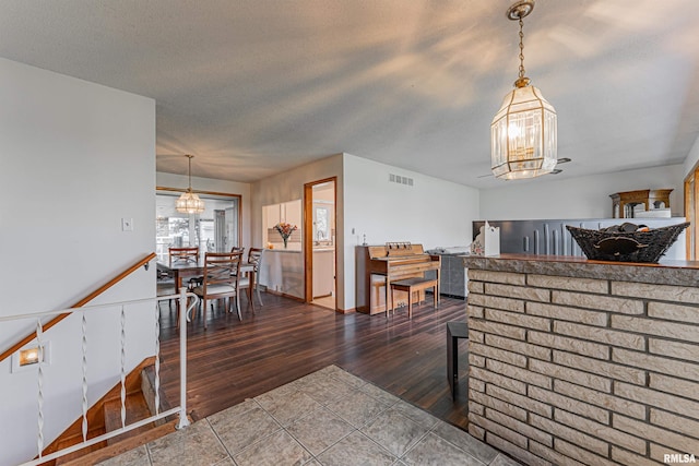 1354 Airport Rd, Lincoln, IL 62656 - dining area with a chandelier, wood finished floors, and a textured ceiling