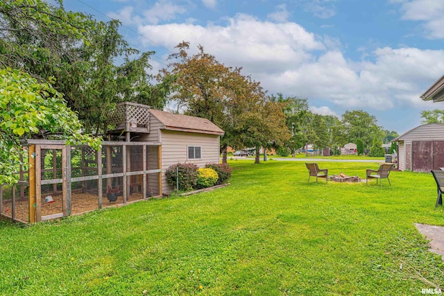 1354 Airport Rd, Lincoln, IL 62656 - view of green lawn featuring an outdoor structure, exterior structure, and an outdoor fire pit