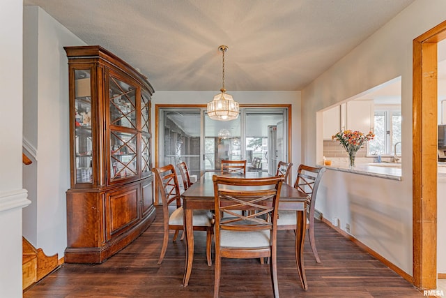 1354 Airport Rd, Lincoln, IL 62656 - dining room featuring dark wood finished floors, a chandelier, and baseboards
