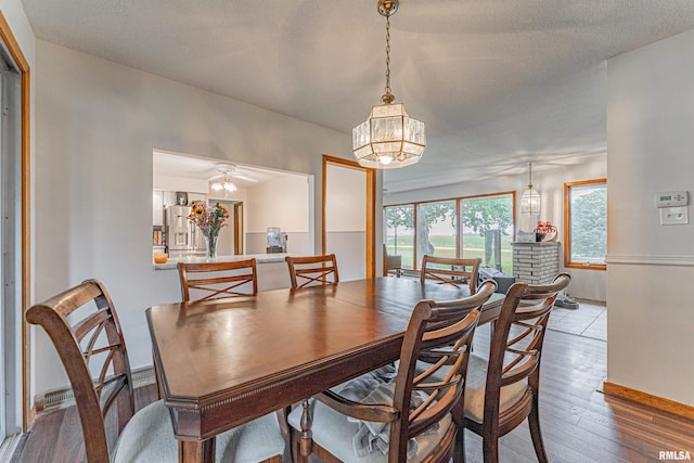 1354 Airport Rd, Lincoln, IL 62656 - dining room featuring hardwood / wood-style flooring, a chandelier, and baseboards