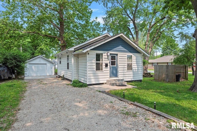 2705 S Walnut St, Springfield, IL 62704 - view of front facade with driveway, a detached garage, an outdoor structure, and entry steps