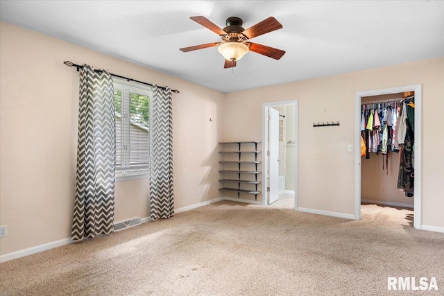 69 Axline Rd, Chatham, IL 62629 - unfurnished bedroom with a spacious closet, carpet, a closet, and a ceiling fan