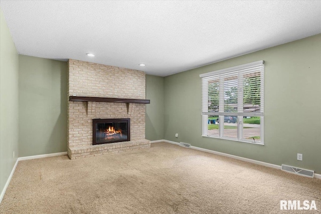 69 Axline Rd, Chatham, IL 62629 - unfurnished living room with carpet flooring, a textured ceiling, a fireplace, and recessed lighting