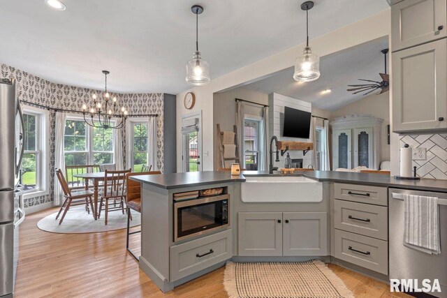 33 Vista Rdg, Petersburg, IL 62675 - kitchen featuring appliances with stainless steel finishes, a sink, dark countertops, a chandelier, and decorative backsplash