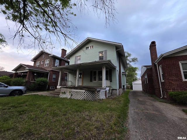 2040 S 5th St, Springfield, IL 62703 - view of front of house with a porch, a front yard, and an outdoor structure