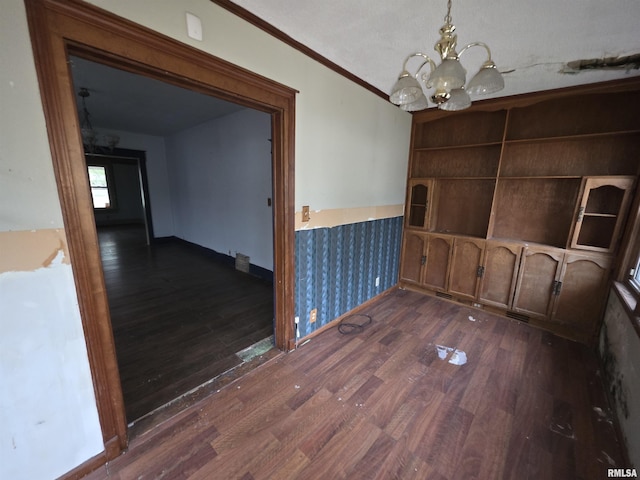 2040 S 5th St, Springfield, IL 62703 - unfurnished dining area featuring dark wood-type flooring, a chandelier, ornamental molding, and baseboards