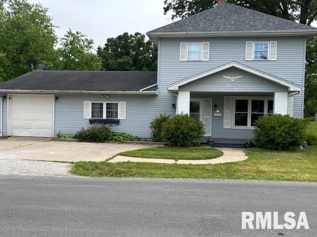 505 E Elm St, Carlinville, IL 62626 - view of front of house featuring covered porch, a chimney, a garage, a front lawn, and roof with shingles