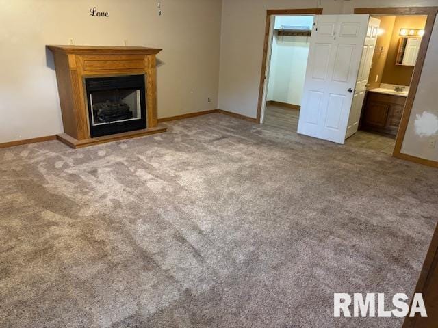 505 E Elm St, Carlinville, IL 62626 - unfurnished living room featuring carpet flooring, baseboards, and a fireplace