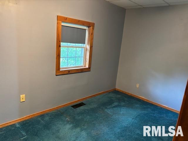 505 E Elm St, Carlinville, IL 62626 - unfurnished room featuring carpet flooring, a paneled ceiling, and baseboards