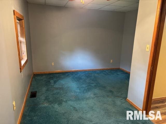 505 E Elm St, Carlinville, IL 62626 - carpeted empty room featuring a drop ceiling, baseboards, and a ceiling fan