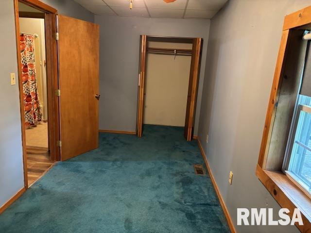 505 E Elm St, Carlinville, IL 62626 - unfurnished bedroom featuring a paneled ceiling, carpet floors, and baseboards