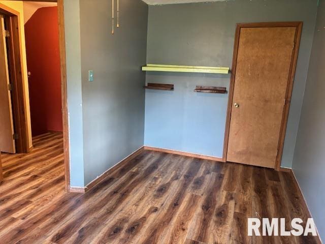 505 E Elm St, Carlinville, IL 62626 - unfurnished bedroom featuring wood finished floors and baseboards
