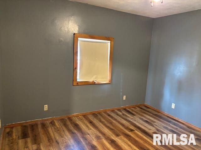 505 E Elm St, Carlinville, IL 62626 - spare room with wood finished floors and baseboards