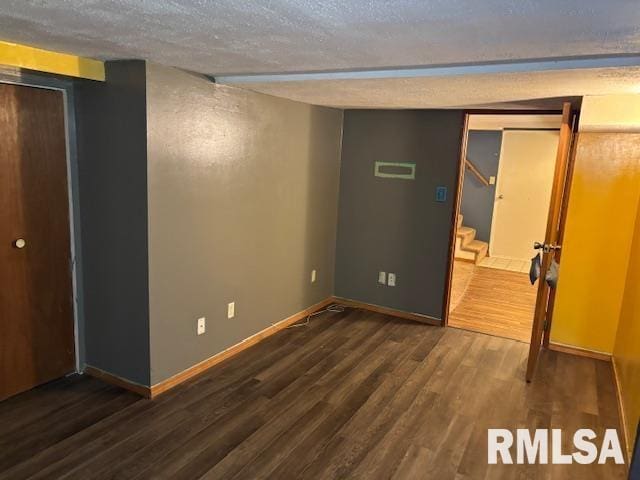 505 E Elm St, Carlinville, IL 62626 - unfurnished bedroom with a textured ceiling, wood finished floors, and baseboards