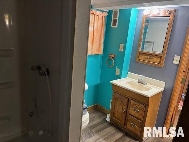 505 E Elm St, Carlinville, IL 62626 - full bath with toilet, vanity, and wood finished floors