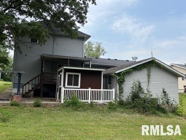 505 E Elm St, Carlinville, IL 62626 - rear view of house with a lawn and a wooden deck