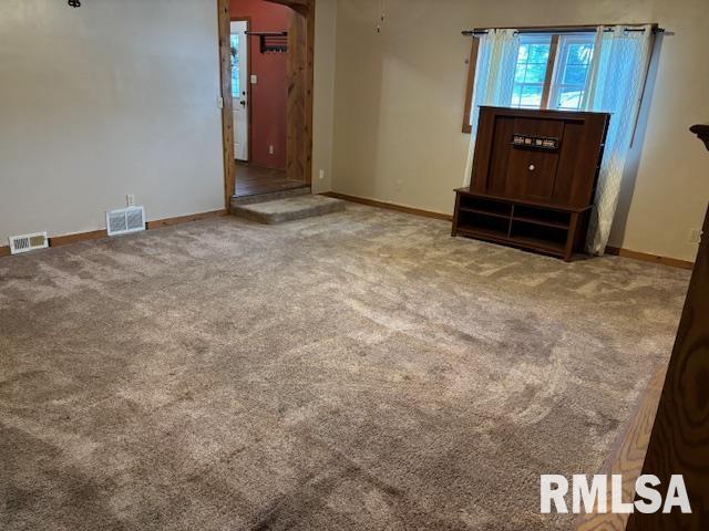 505 E Elm St, Carlinville, IL 62626 - unfurnished living room with carpet and baseboards