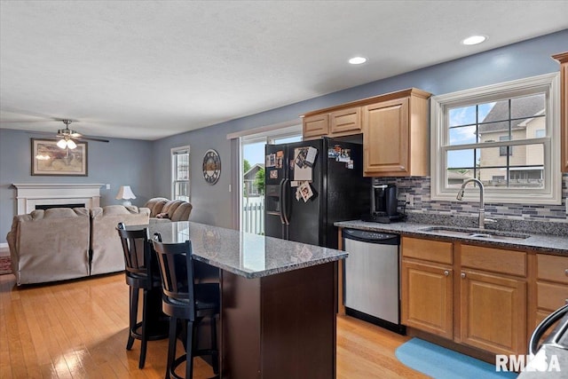 4108 Newtonmore Dr, Springfield, IL 62712 - kitchen with dishwasher, a sink, black fridge, a kitchen island, and a ceiling fan
