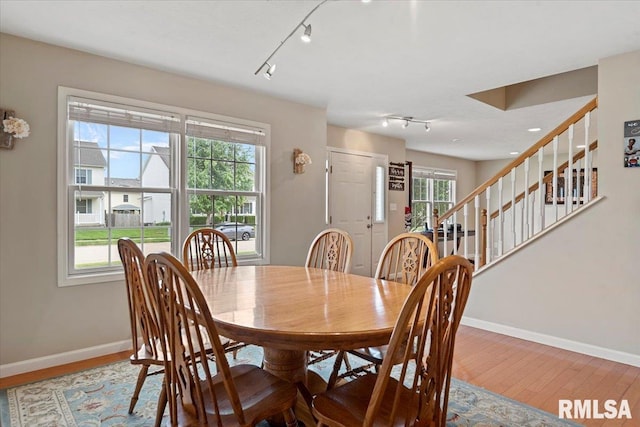 4108 Newtonmore Dr, Springfield, IL 62712 - dining room with rail lighting, baseboards, stairway, and wood finished floors