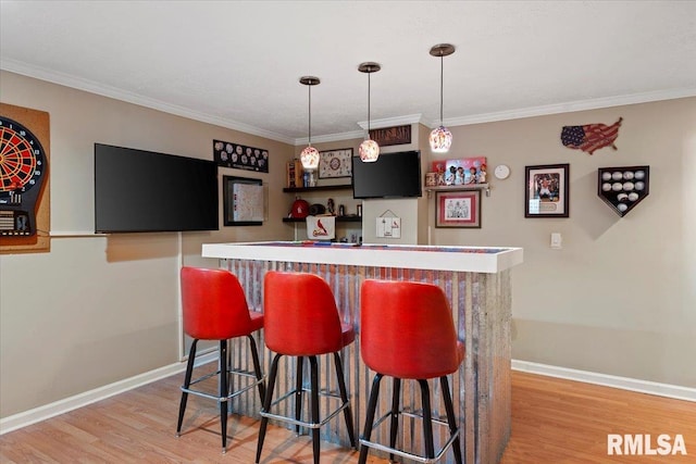 4108 Newtonmore Dr, Springfield, IL 62712 - indoor wet bar with light wood finished floors, baseboards, ornamental molding, and hanging light fixtures
