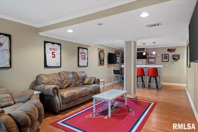 4108 Newtonmore Dr, Springfield, IL 62712 - living area featuring light wood-style flooring, bar, baseboards, crown molding, and recessed lighting