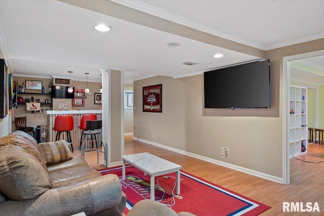 4108 Newtonmore Dr, Springfield, IL 62712 - living area featuring ornamental molding, a bar, wood finished floors, baseboards, and recessed lighting