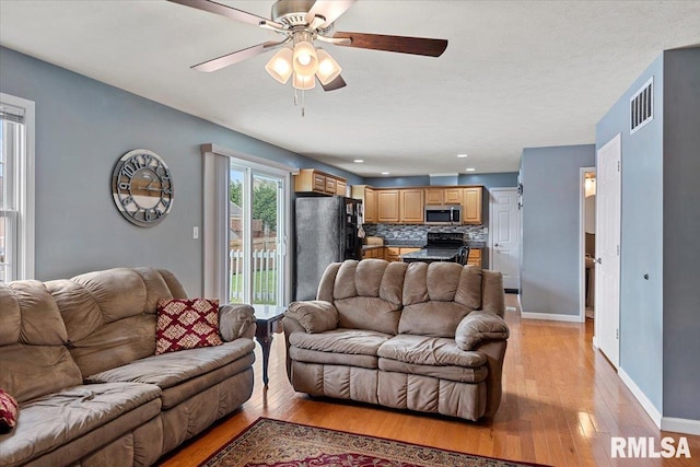 4108 Newtonmore Dr, Springfield, IL 62712 - living area with light wood-style floors, baseboards, and a ceiling fan