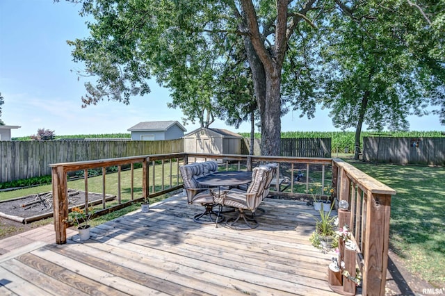 909 E Heights Ave, Taylorville, IL 62568 - wooden deck featuring a shed, a fenced backyard, and outdoor dining area