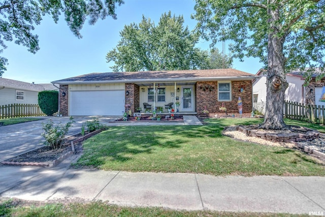 909 E Heights Ave, Taylorville, IL 62568 - single story home with brick siding, a garage, covered porch, and concrete driveway
