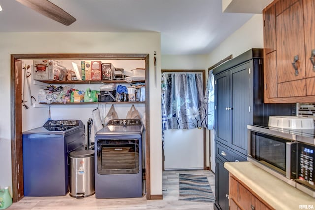 909 E Heights Ave, Taylorville, IL 62568 - kitchen with stainless steel microwave, washing machine and clothes dryer, and light wood finished floors