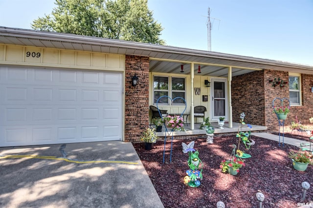 909 E Heights Ave, Taylorville, IL 62568 - single story home with a porch, brick siding, an attached garage, driveway, and board and batten siding