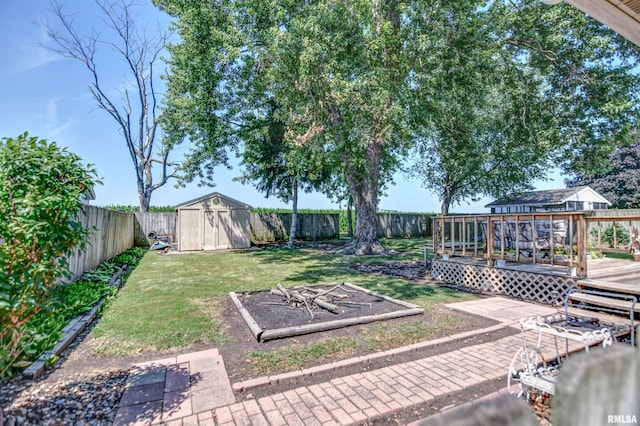 909 E Heights Ave, Taylorville, IL 62568 - fenced backyard featuring a storage unit and a deck