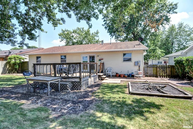 909 E Heights Ave, Taylorville, IL 62568 - rear view of property featuring a fenced backyard, a garden, and a wooden deck