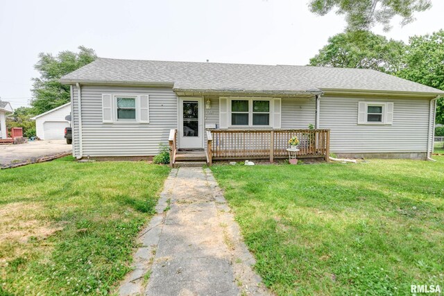 128 Macarthur Blvd, Pana, IL 62557 - single story home with a front lawn, roof with shingles, a porch, and a detached garage