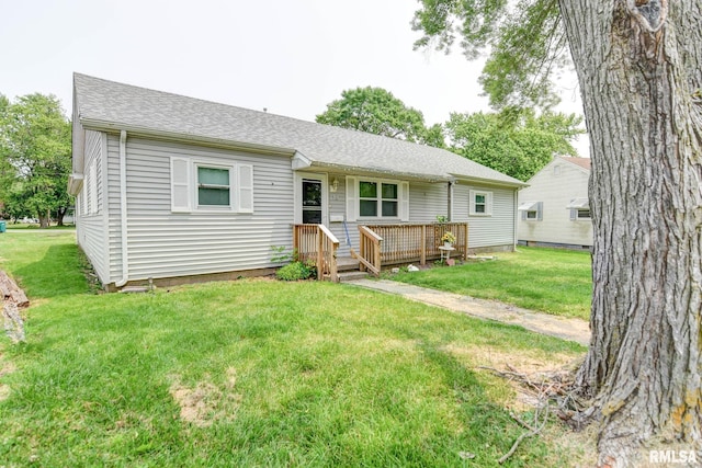 128 Macarthur Blvd, Pana, IL 62557 - view of front facade with a front yard, a shingled roof, and a wooden deck