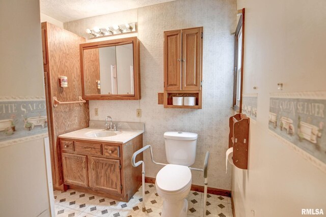 128 Macarthur Blvd, Pana, IL 62557 - bathroom featuring vanity, toilet, tile walls, and tile patterned floors